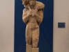 "MOSCHOFOROS". THE STATUE OF A BEARDED YOUNG MAN MADE OF HYMETTIAN MARBLE. AROUND 570 BC. AT THE ACROPOLIS MUSEUM, ATHENS, GREECE